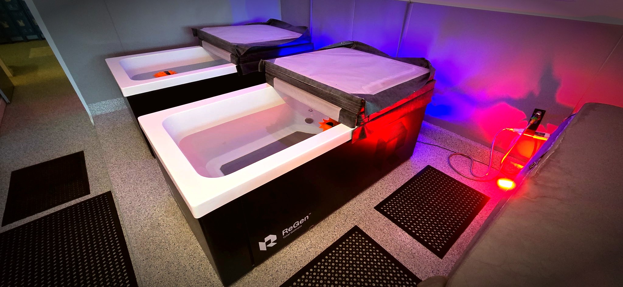 ReGen cold plunge tubs with insulated covers and blue-red ambient lighting