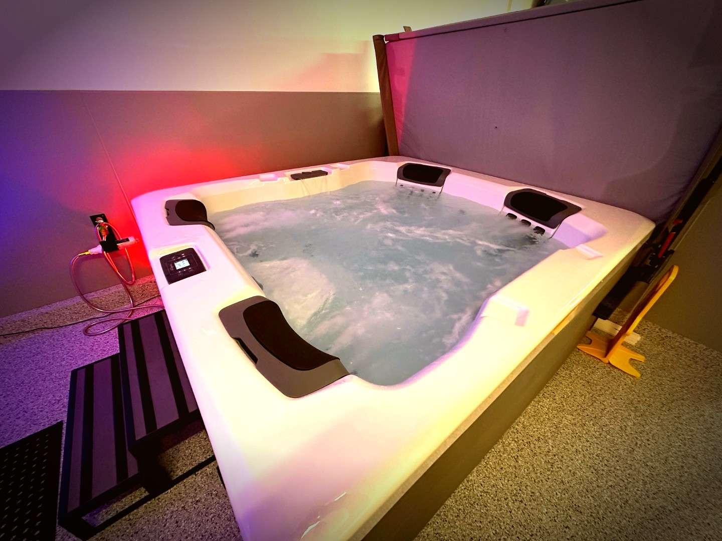 Large hot tub with ambient purple and red lighting