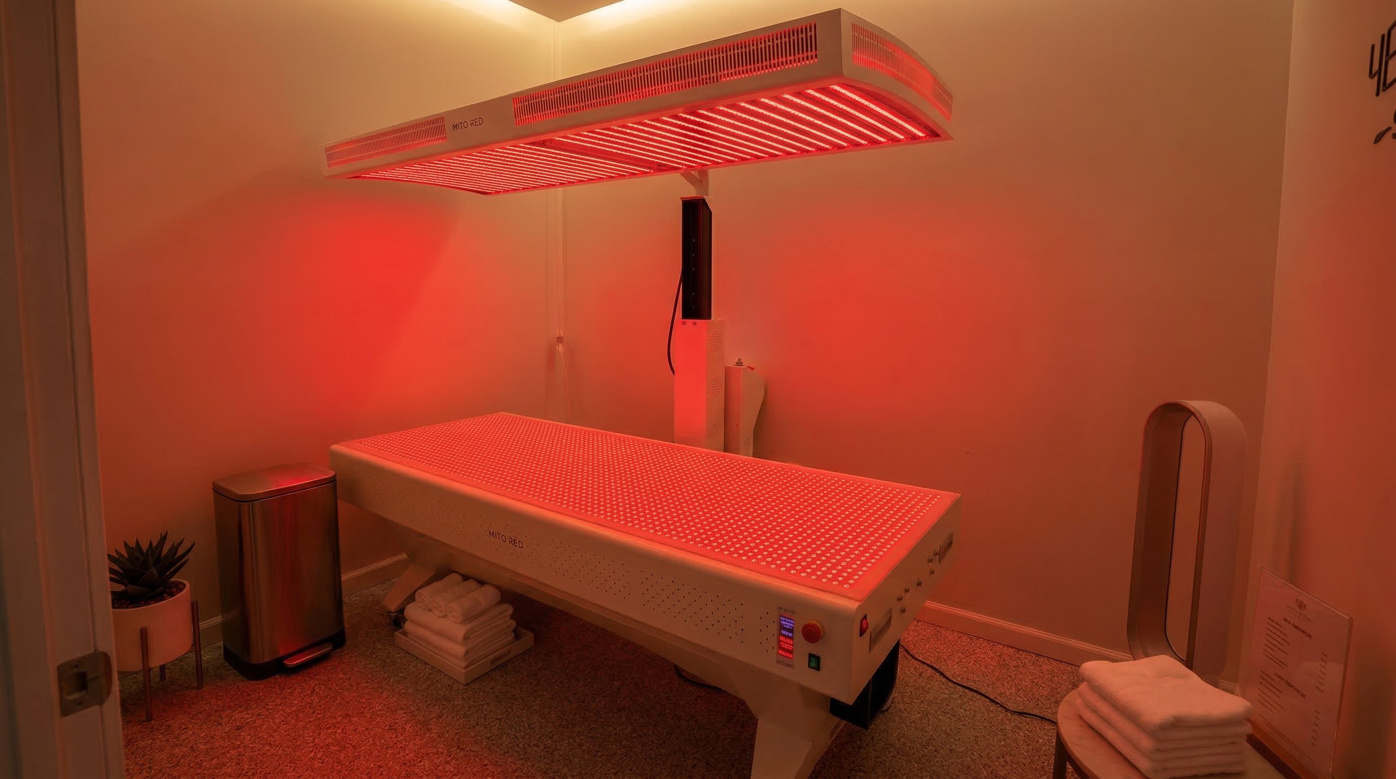 Mito Red full-body red light therapy bed glowing in a dedicated room